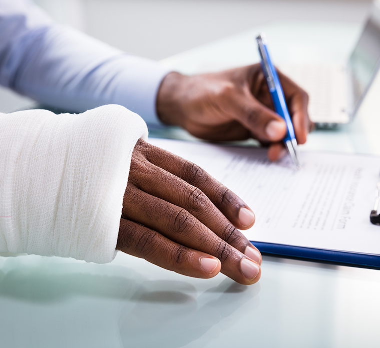 Man filling out worker's Compensation application with cast on his wrist